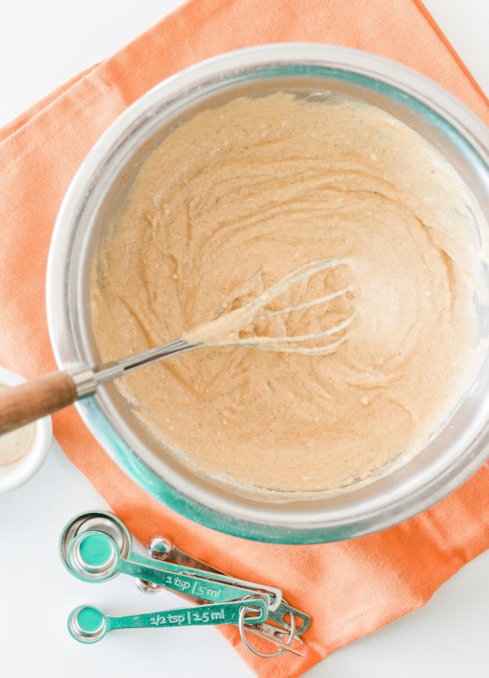 Mixing the pumpkin pancakes mixture in a bowl.