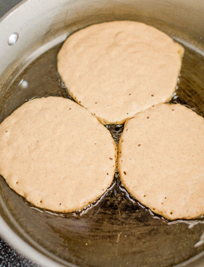 Cooking the pumpkin pancakes in a pan.