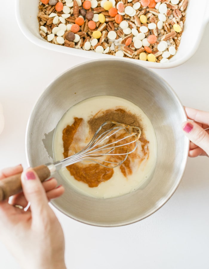 Mixing the pumpkin bars mixture in a bowl.