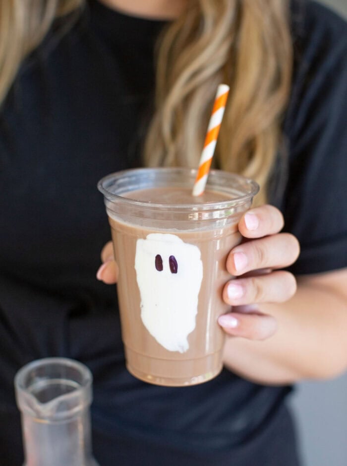 Ghost chocolate milk cup with a straw, one of these Halloween drinks.
