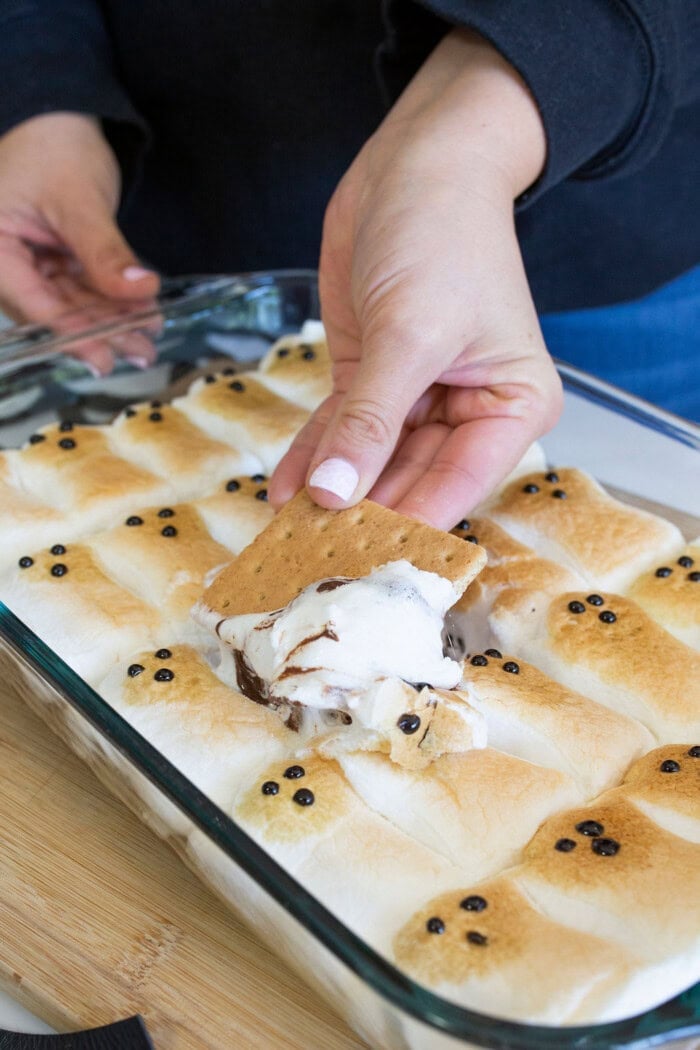 Dipping graham crackers into the Halloween s’mores dip.