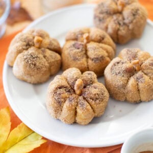 Pumpkin cinnamon rolls on a plate.
