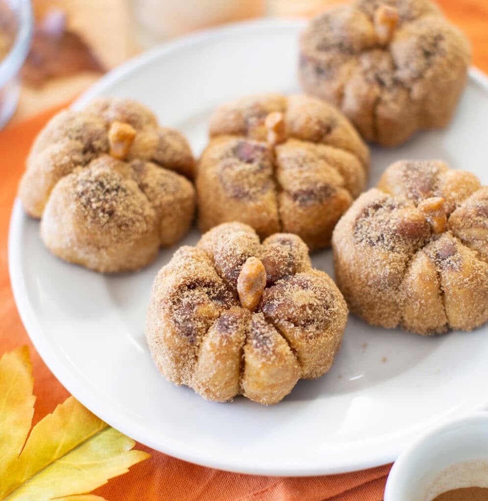 Pumpkin cinnamon rolls on a plate.