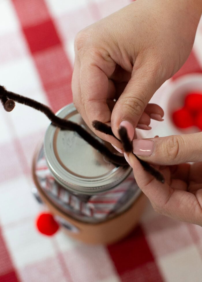 Shaping the reindeer antlers on top of the candy jar lid.
