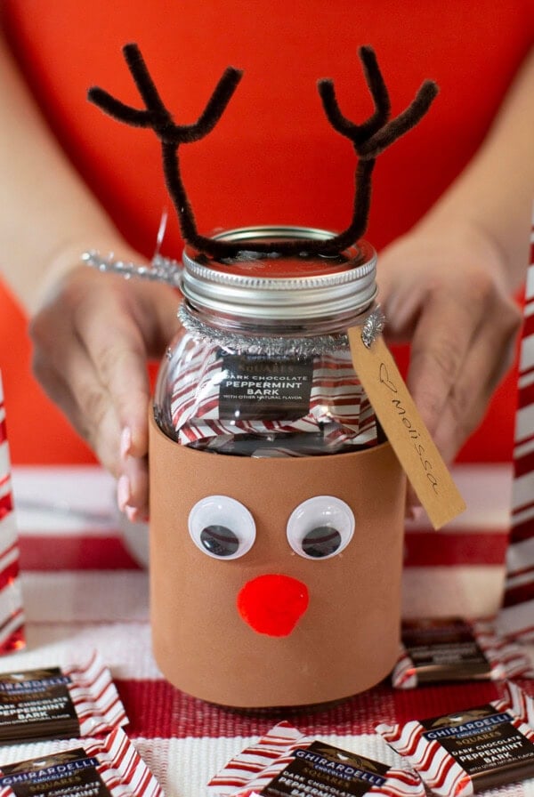 Two hands holding Reindeer candy jar.