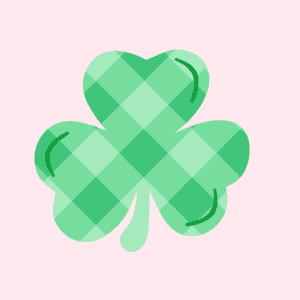A green plaid-patterned shamrock with three heart-shaped leaves on a light pink background.